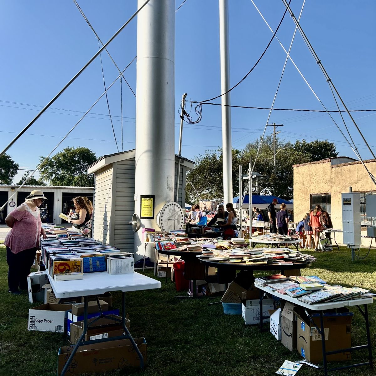 Many tables pilled high with books for sale