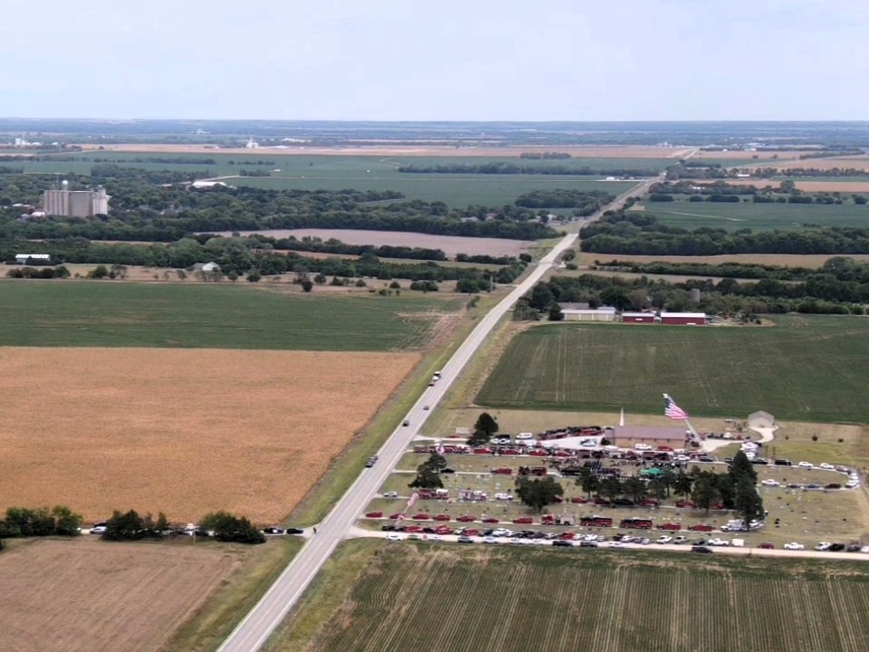 A funeral for fallen firefighter service at the cemetery, Whitewater can be seen in the up portion of the image