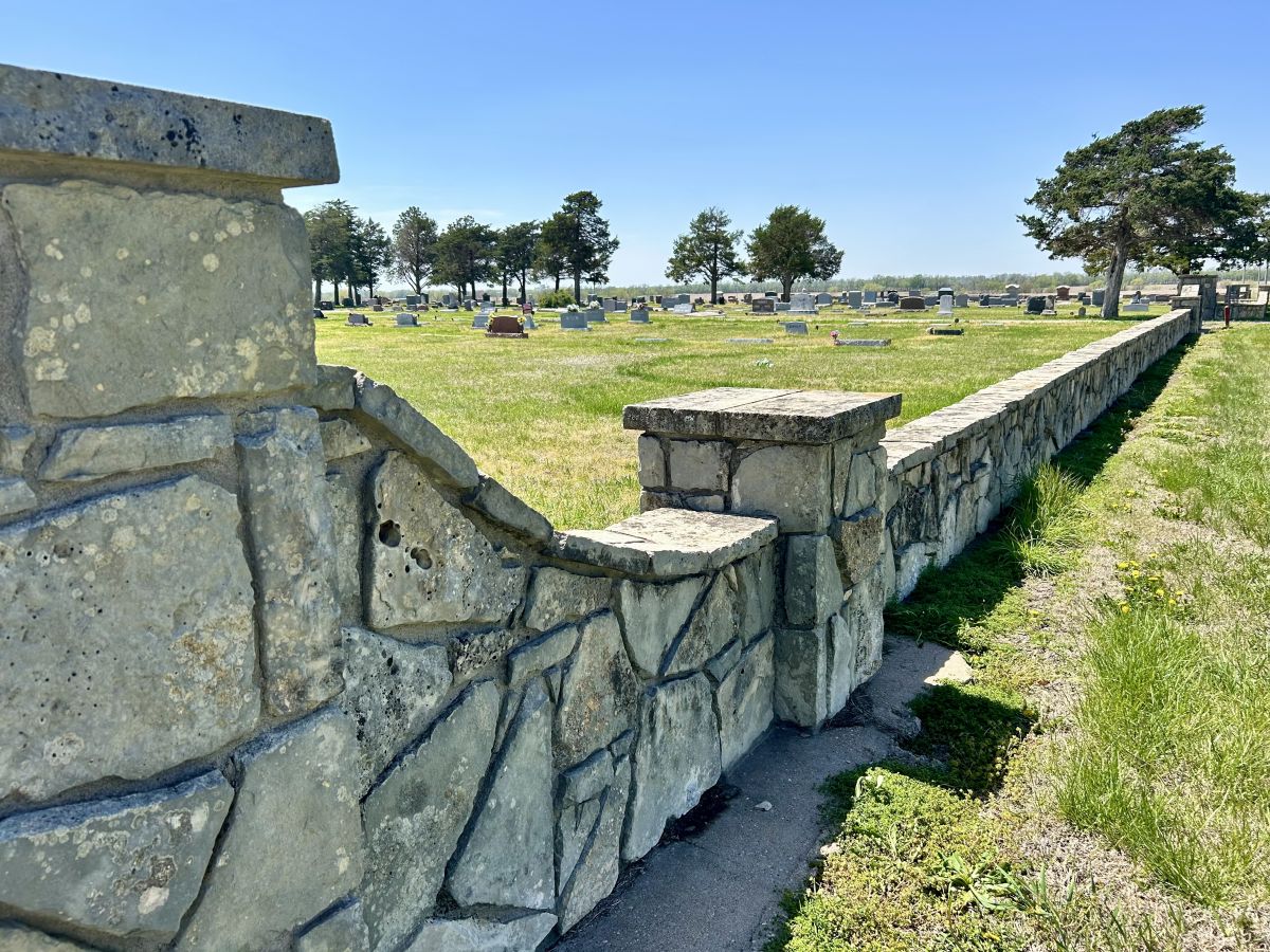 Stone Wall runs the entire North side (HWY side) of the Cemetery with seperate entrances for each roadway