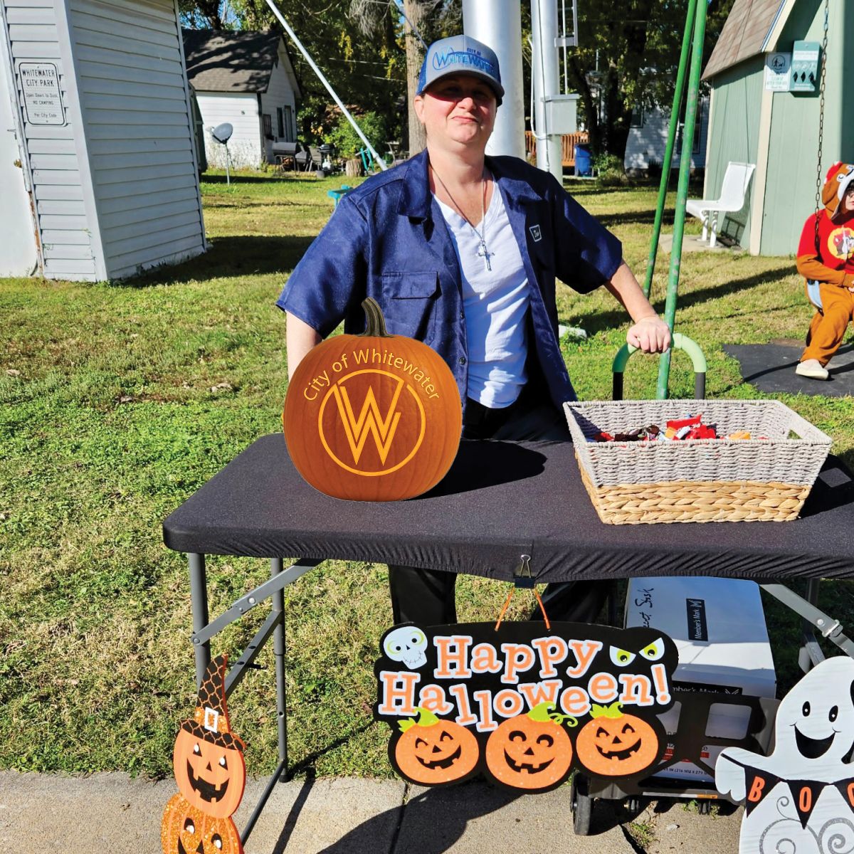 City lady dressed up for halloween handing out candy