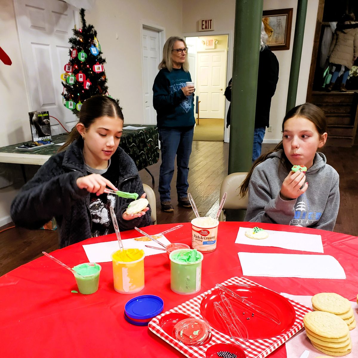 teens decorating and eating sugar cookies