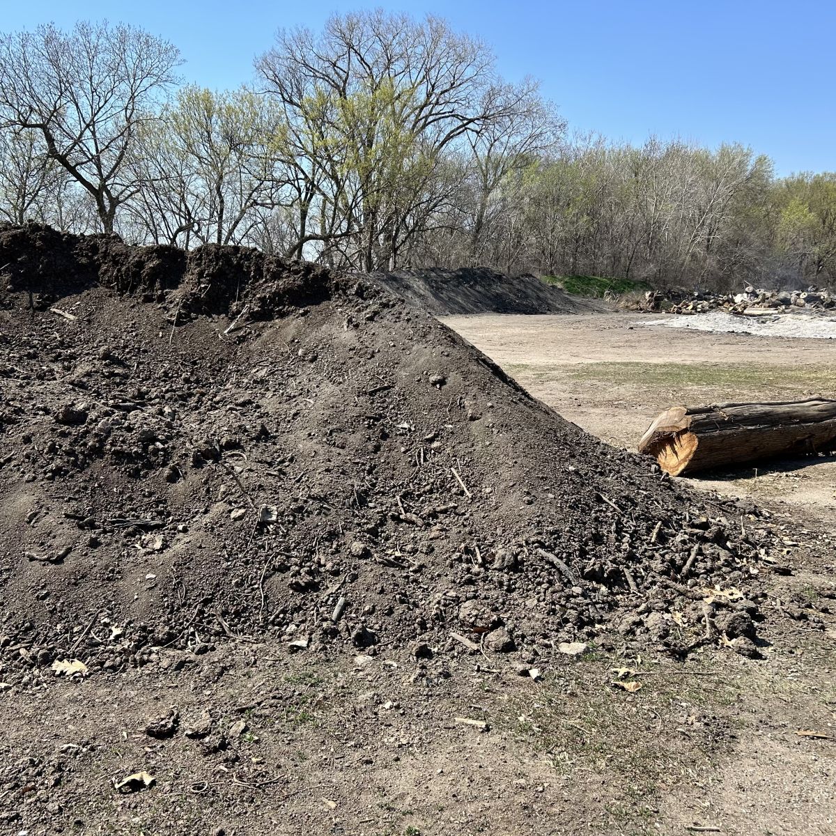 Dirt Pile with a burn pile behind it