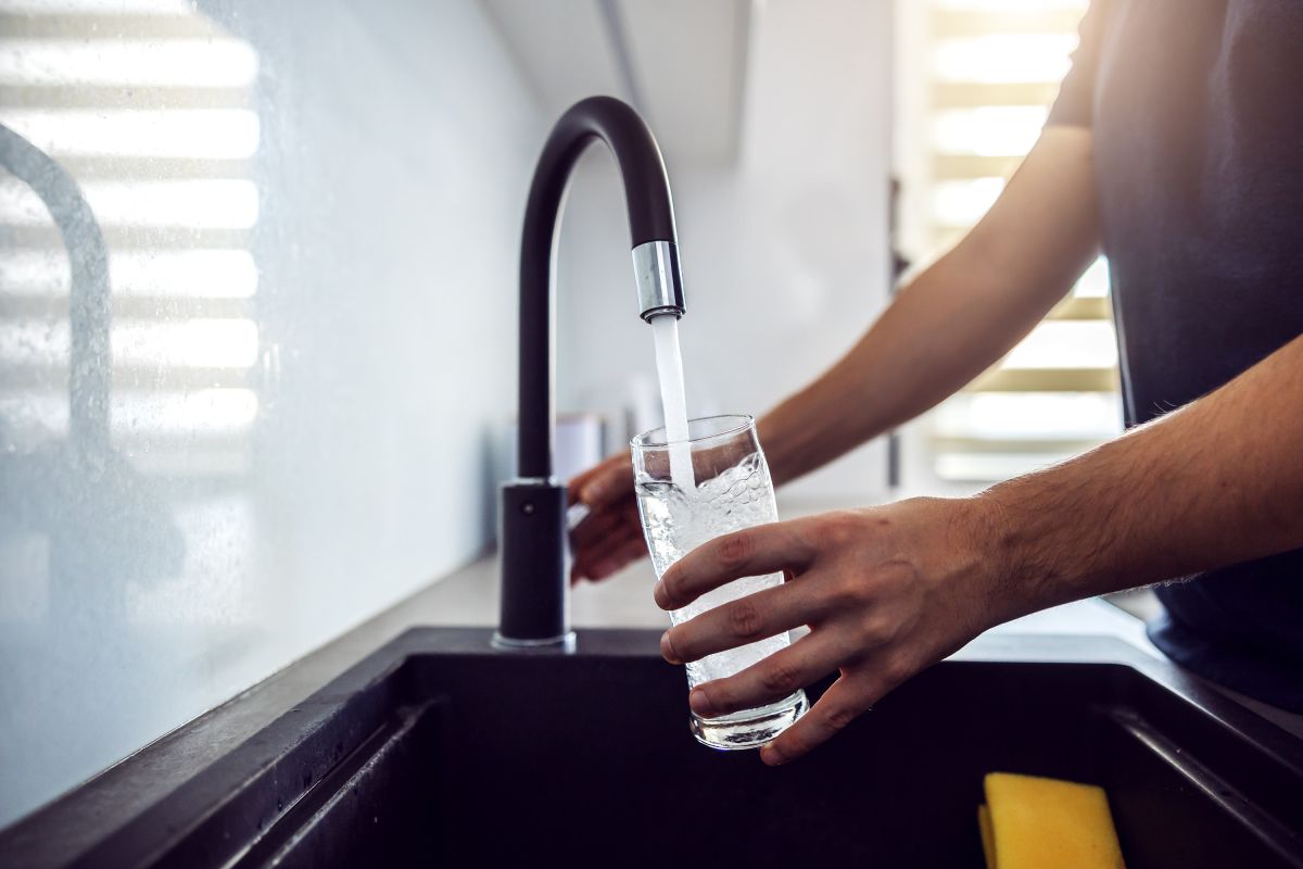 filling up a glass of water from the sink