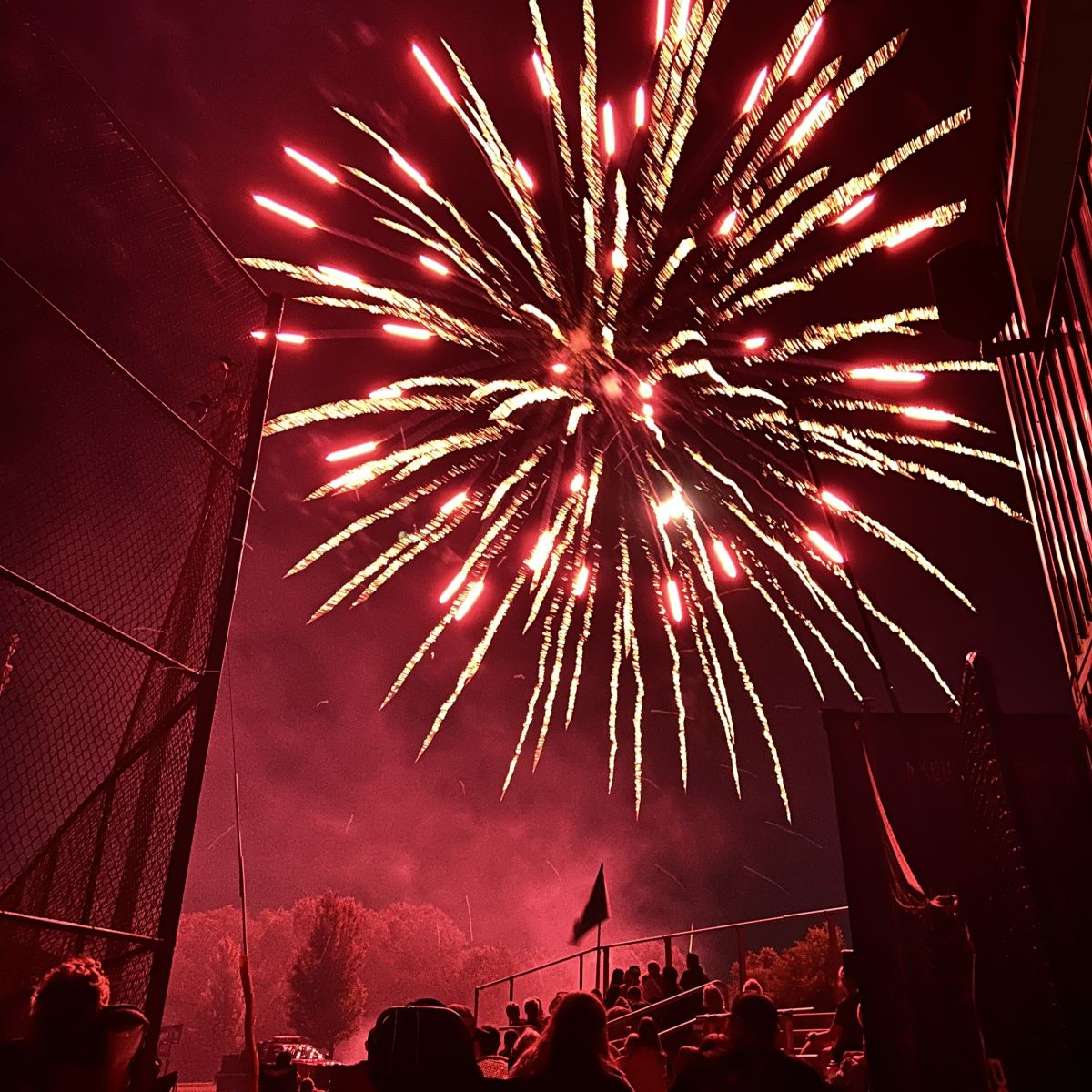 Red Fireworks light up the evening sky the end the evening