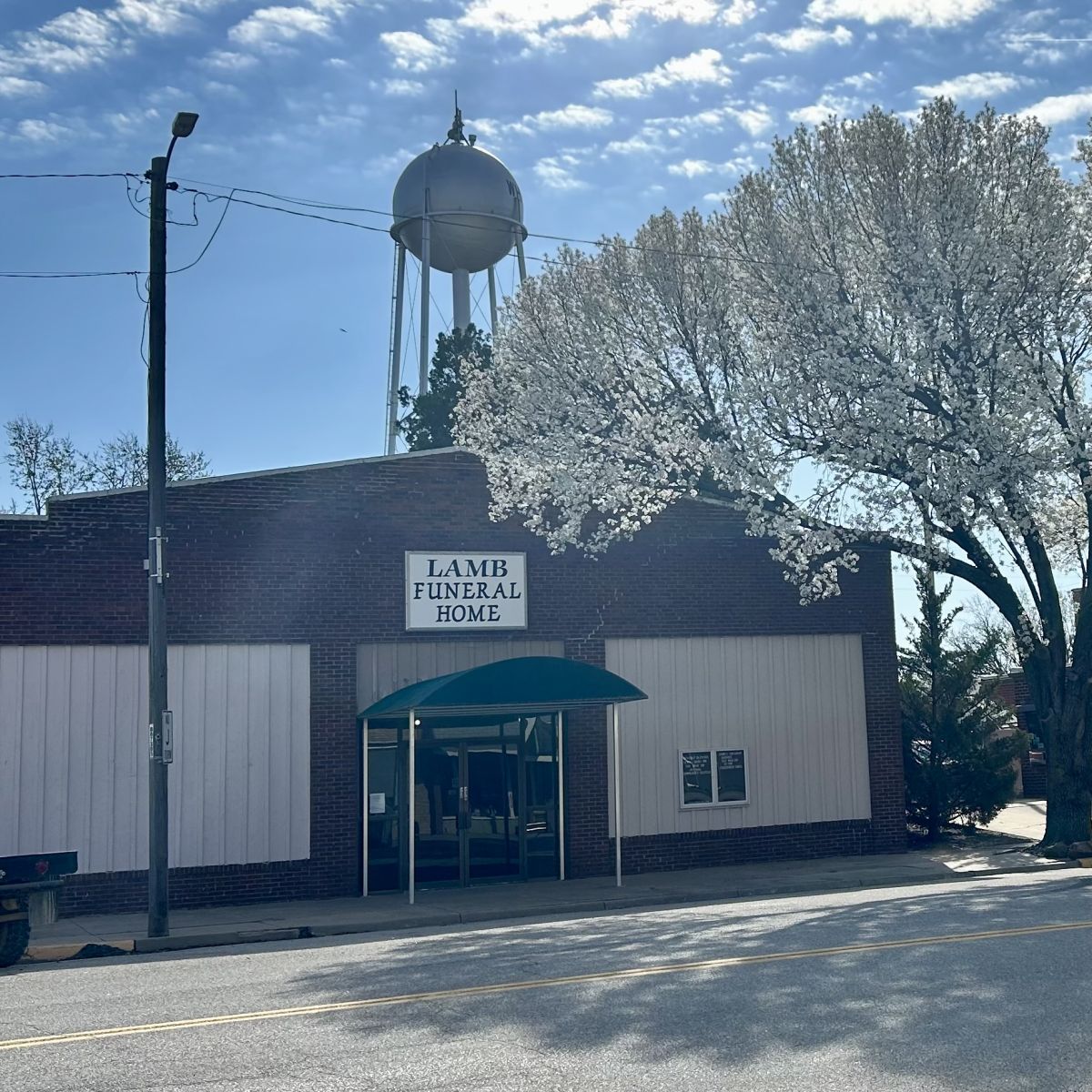 Brick building with a sign saying Lamb Funeral Home
