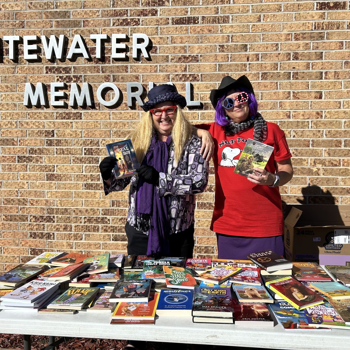 Library workers dressed up handing out books
