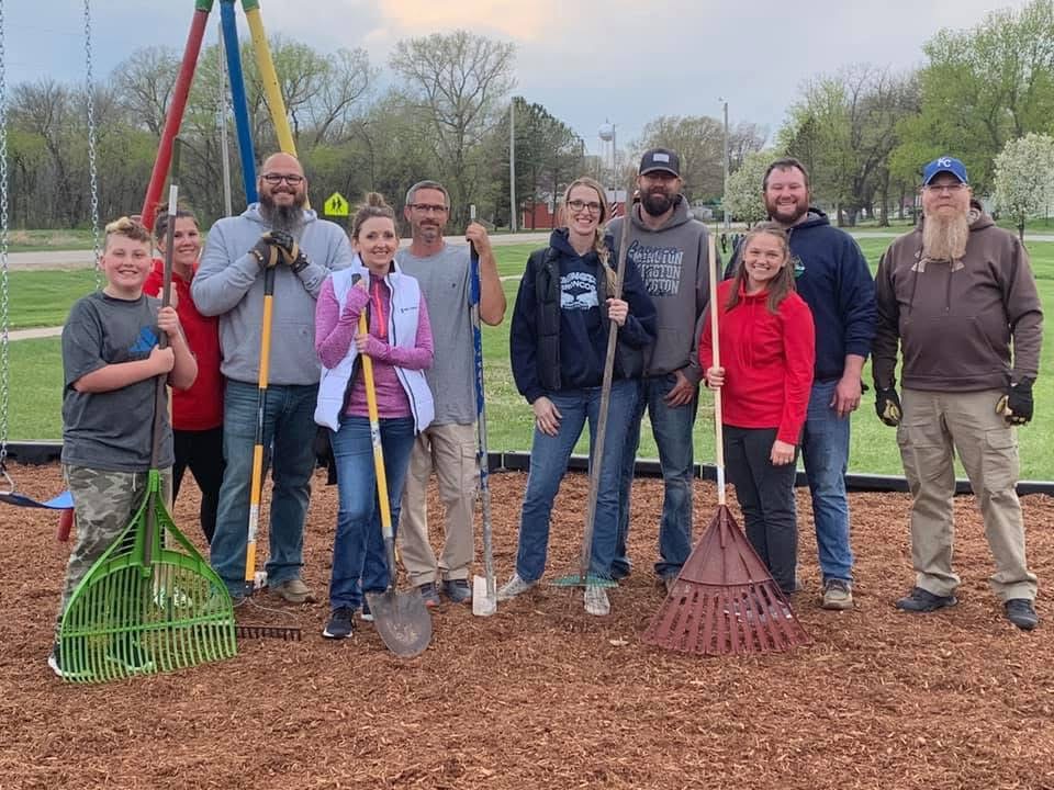 workers pose after installing park equipment