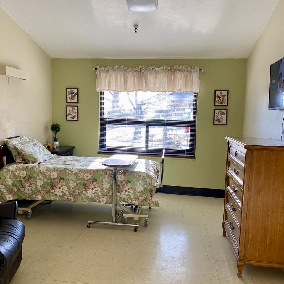 example of a room, bed, chair, dresser, tv and window