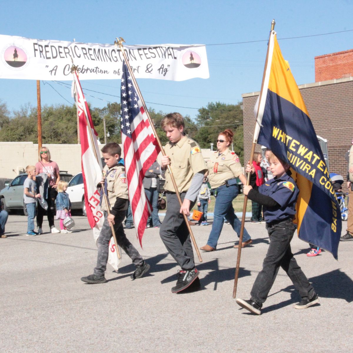 scouts holding flags marching in parade