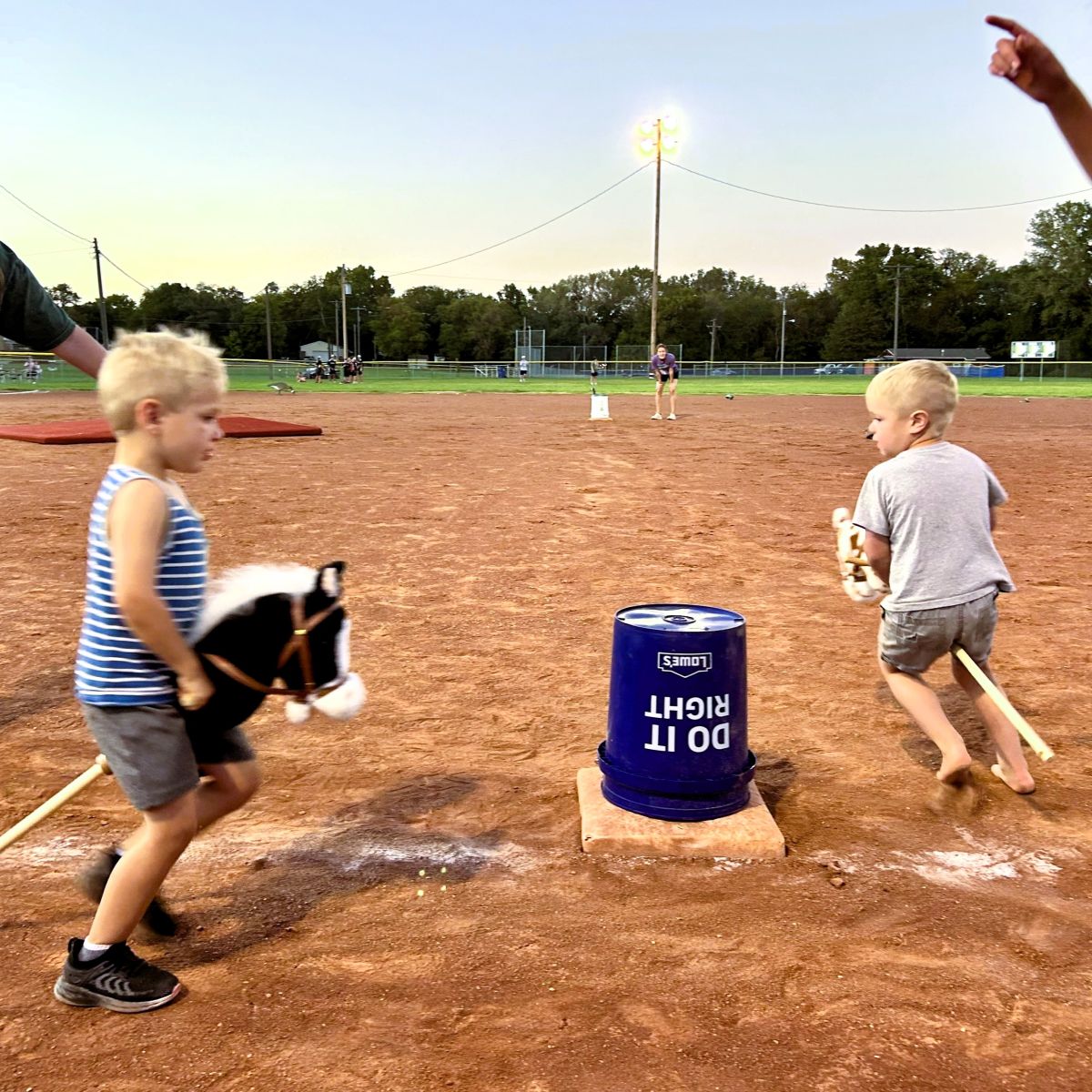 two boys racing with stick horses
