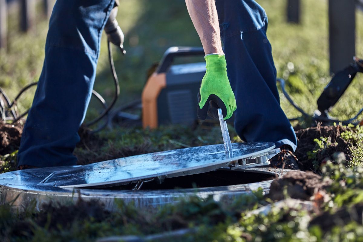 man opening up a meter can for services