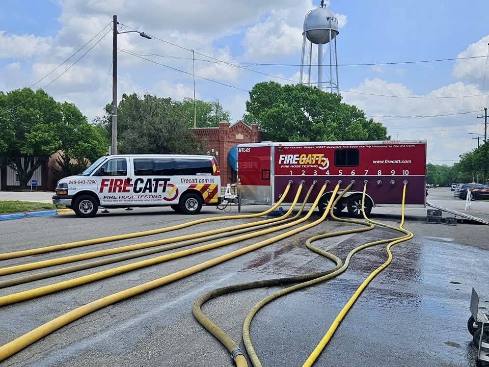 multiple fire hoses attached to different trucks