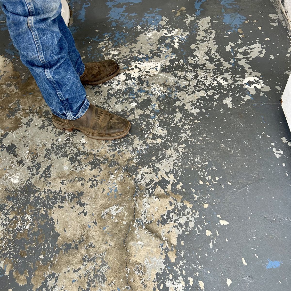 rough looking public bathroom floor before paint